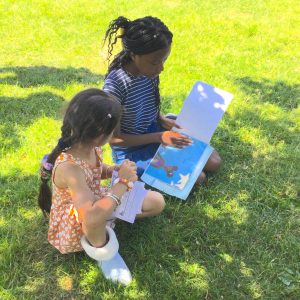girls reading outdoors