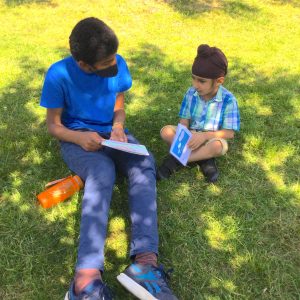 boys reading stories outdoors