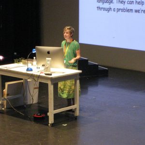 illustrator speaking on stage