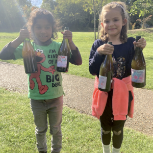 children holding glass bottles
